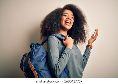 Young African American Student Woman With Afro Hair Wearing Backpack Over Background Very Happy And Excited, Winner Expression Celebrating Victory Screaming With Big Smile And Raised Hands