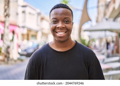 Young african american transgender smiling confident at street