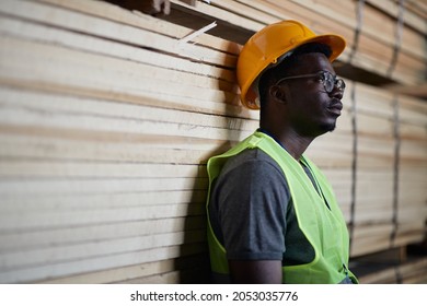 Young African American Warehouse Worker Thinking Of Something While Working At Lumber Distribution Department.