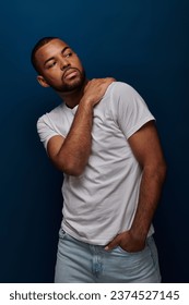 young african american in white shirt and jeans gesturing and looking away, fashion concept
