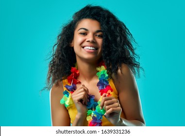 Young African American Woman With Afro Hair Wearing Flower Hawaiian Lei  Very Happy And Excited Wearing Yellow Top Isolated On Blue Background.