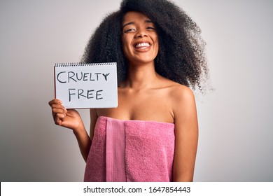 Young african american woman with afro hair wearing a towel asking for cruelty free beauty with a happy face standing and smiling with a confident smile showing teeth