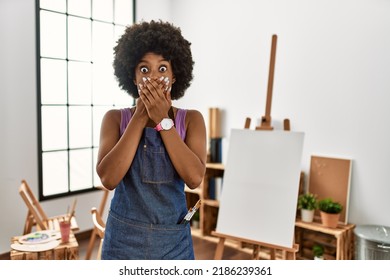 Young African American Woman With Afro Hair At Art Studio Shocked Covering Mouth With Hands For Mistake. Secret Concept. 