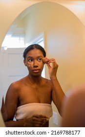 Young African American Woman Applying Concealer