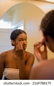 Young African American Woman Applying Concealer