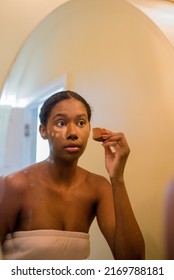 Young African American Woman Applying Concealer