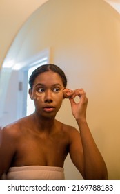 Young African American Woman Applying Concealer