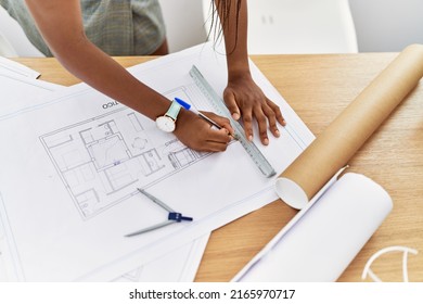 Young African American Woman Architect Writing On House Plans At Architecture Studio