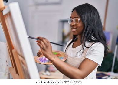 Young african american woman artist smiling confident drawing at art studio