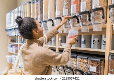 Young African American Woman Buying Cereals And Grains In Sustainable Grocery Store