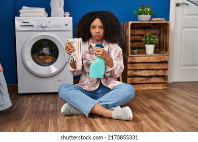 Young African American Woman Cleaning Shoes At Laundry Room Depressed And Worry For Distress, Crying Angry And Afraid. Sad Expression. 