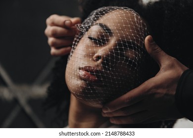 Young African American Woman With Curly Hair With A Grid On Her Face