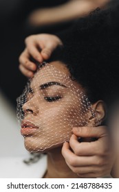 Young African American Woman With Curly Hair With A Grid On Her Face