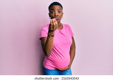 Young African American Woman Expecting A Baby, Touching Pregnant Belly Doing Italian Gesture With Hand And Fingers Confident Expression 