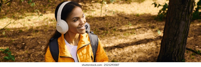 A young African American woman explores a colorful autumn forest, radiating joy and adventure. - Powered by Shutterstock