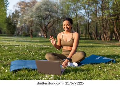 Young African American Woman Greeting Personal Coach, Having Online Fitness Class On Laptop At City Park, Copy Space. Millennial Black Lady Talking To Trainer On Web During Outdoor Workout