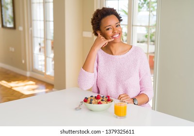 Young african american woman having healthy breakfast in the morning at home smiling doing phone gesture with hand and fingers like talking on the telephone. Communicating concepts. - Shutterstock ID 1379325611