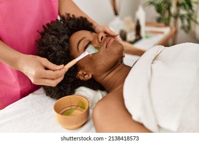 Young African American Woman Having Facial Treatment At Beauty Center