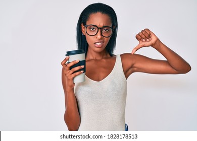 Young African American Woman Holding Take Away Coffee With Angry Face, Negative Sign Showing Dislike With Thumbs Down, Rejection Concept 