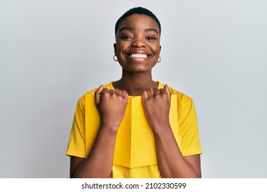 Young African American Woman Holding Book Smiling With A Happy And Cool Smile On Face. Showing Teeth. 