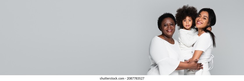 Young African American Woman With Mother And Daughter Smiling At Camera Isolated On Grey, Banner