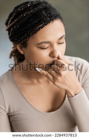 Young african american woman practicing nostril breathing and meditation in yoga studio