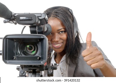 A Young African American Woman With Professional Video Camera And Headphone