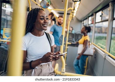 Young african american woman reading a text message on her smartphone while riding a bus. Black woman catching up on social media while in a bus during her morning commute. Copy space. - Powered by Shutterstock