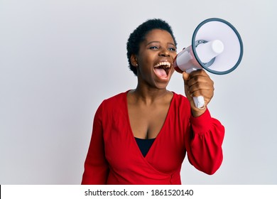 Young african american woman screaming angry using megaphone over isolated white background. - Powered by Shutterstock