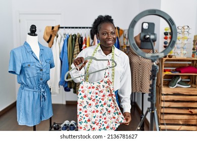 Young African American Woman Shopkeeper Selling Clothes Online At Clothing Store