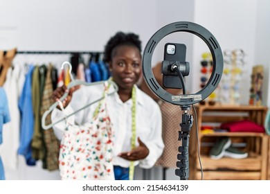 Young African American Woman Shopkeeper Selling Clothes Online At Clothing Store