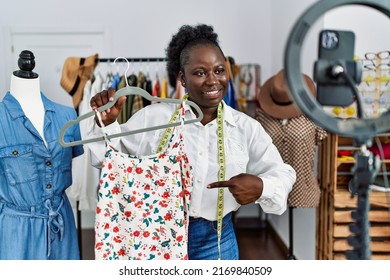 Young African American Woman Shopkeeper Selling Clothes Online At Clothing Store