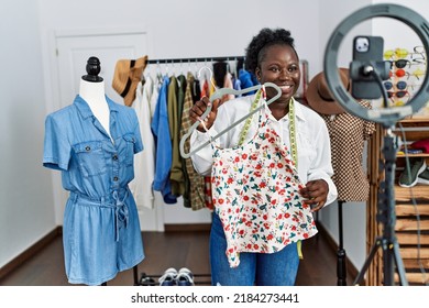 Young African American Woman Shopkeeper Selling Clothes Online At Clothing Store