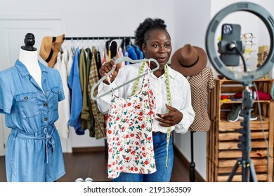 Young African American Woman Shopkeeper Selling Clothes Online At Clothing Store