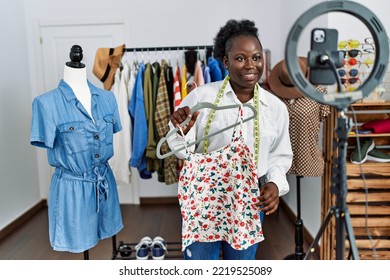 Young African American Woman Shopkeeper Selling Clothes Online At Clothing Store