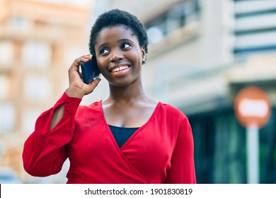 Young african american woman smiling happy talking on the smartphone at the city. - Shutterstock ID 1901830819