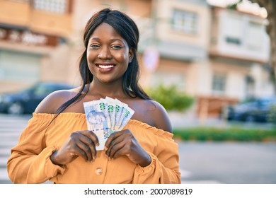 Young African American Woman Smiling Happy Holding South Africa Rands At The City.