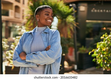 Young african american woman smiling happy with crossed arms at the city. - Powered by Shutterstock