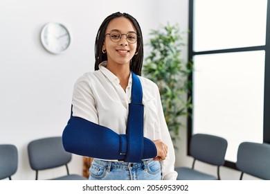 Young african american woman smiling confident injury on arm at clinic waiting room - Powered by Shutterstock