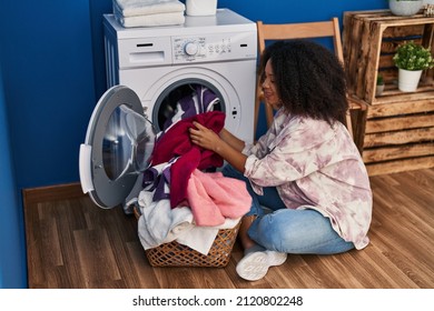 Young African American Woman Smiling Confident Washing Clothes At Laundry