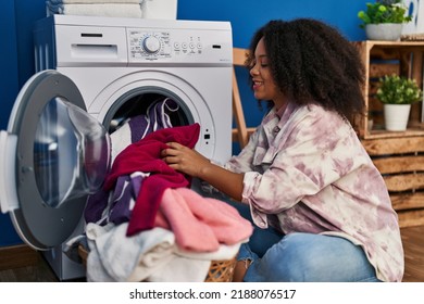 Young African American Woman Smiling Confident Washing Clothes At Laundry