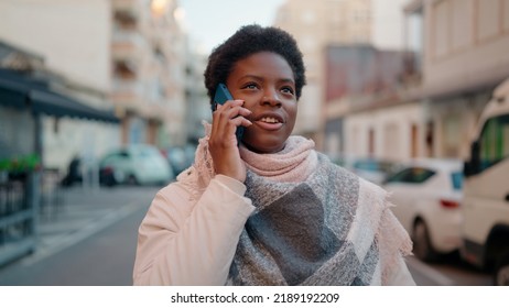 Young african american woman smiling confident talking on the smartphone at street - Shutterstock ID 2189192209