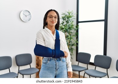 Young african american woman smiling confident injury on arm at clinic waiting room - Powered by Shutterstock