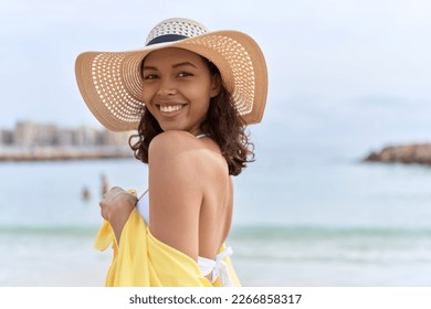 Young african american woman smiling confident wearing summer hat and bikini at beach - Shutterstock ID 2266858317