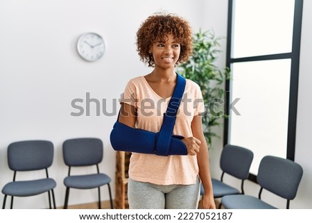 Young african american woman smiling confident injury at clinic waiting room