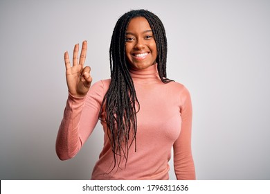 Young african american woman standing casual and cool over white isolated background showing and pointing up with fingers number three while smiling confident and happy. - Powered by Shutterstock