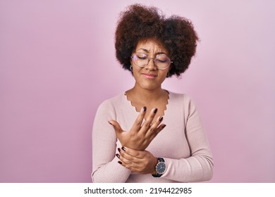 Young African American Woman Standing Over Pink Background Suffering Pain On Hands And Fingers, Arthritis Inflammation 