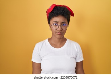 Young african american woman standing over yellow background skeptic and nervous, frowning upset because of problem. negative person.  - Shutterstock ID 2205870071