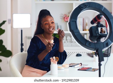 young african american woman streaming a beauty vlog from home, online content creator - Shutterstock ID 1912981339