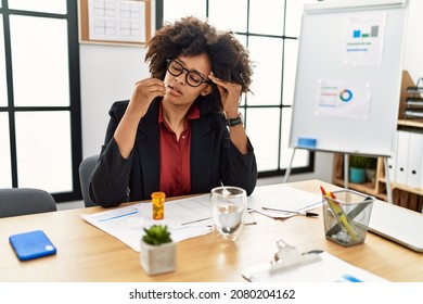 Young African American Woman Taking Pill At Office